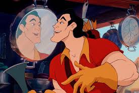 Gaston smiles at his reflection in a shiny pan, flexing in a red shirt with arrows on his back.