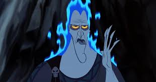Close view of Hades with blue flame hair and half-lidded yellow eyes, raising a hand in bored annoyance against a dark cave.
