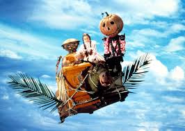 “Return to Oz” still—Dorothy, Jack Pumpkinhead, Tik-Tok, and the Gump soaring through a bright sky on their palm-leaf sofa craft.